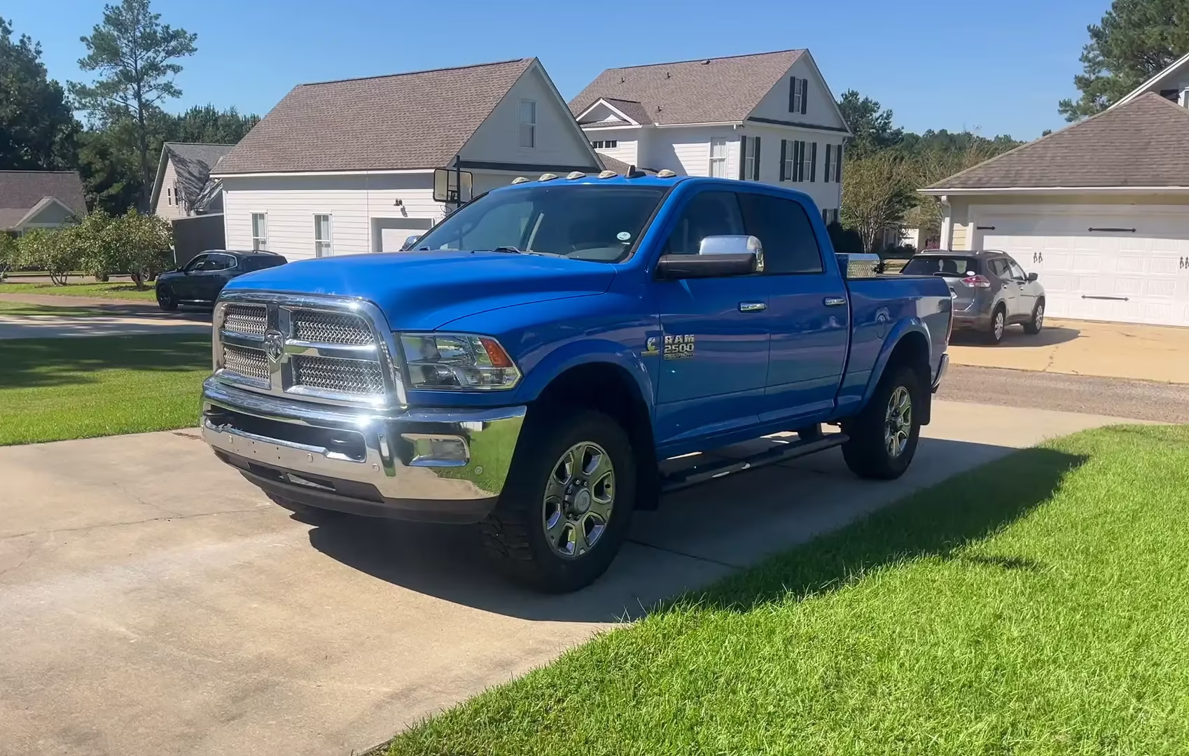 Blue pickup truck parked on a residential driveway