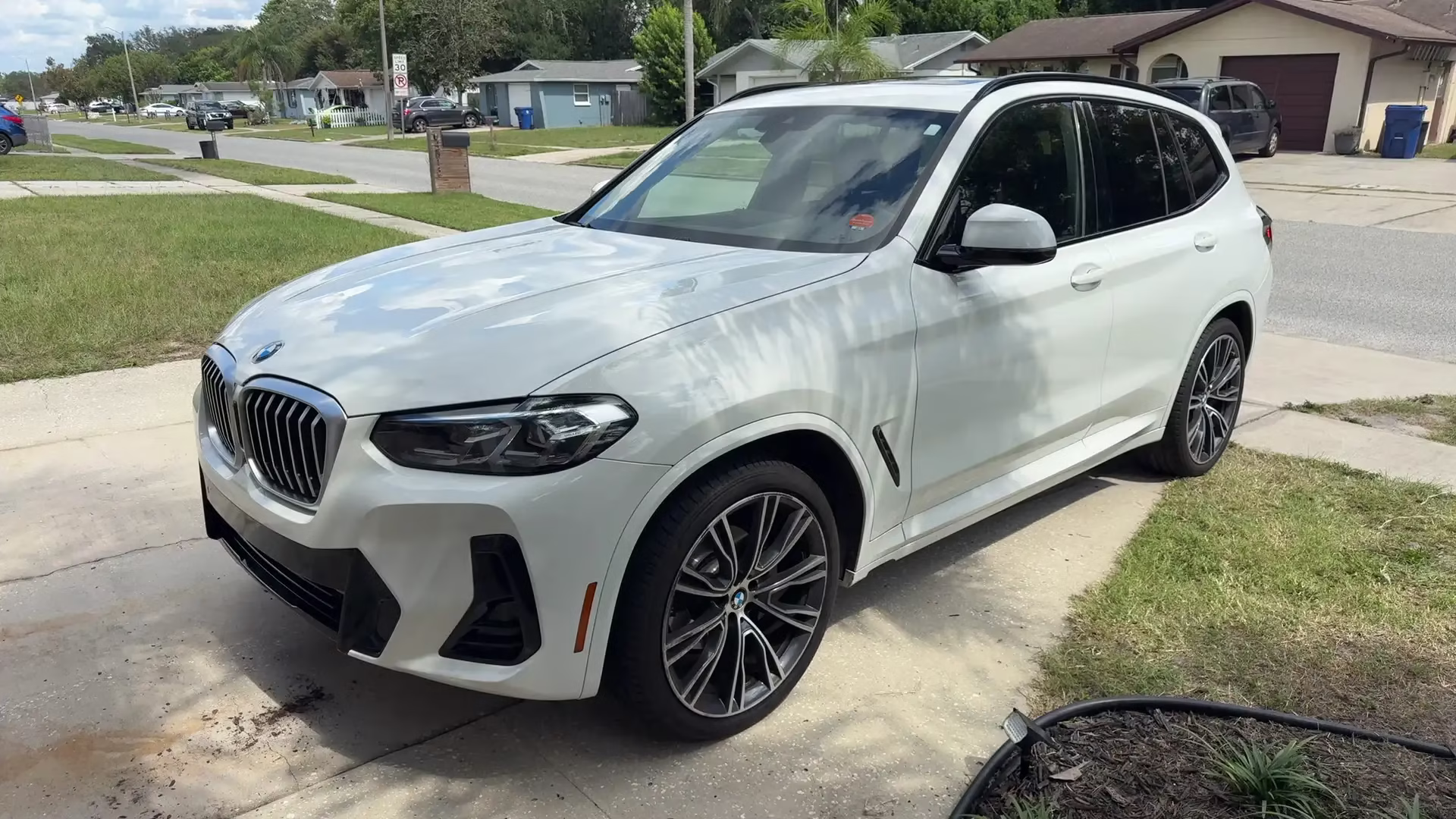 White BMW X3 parked on a residential driveway