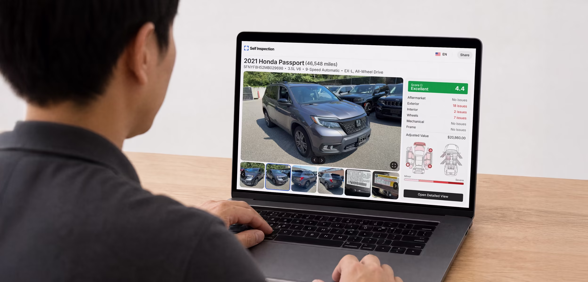 Person at a laptop reviewing a Self Inspection condition report for a 2021 Honda Passport, with a score of 4.4